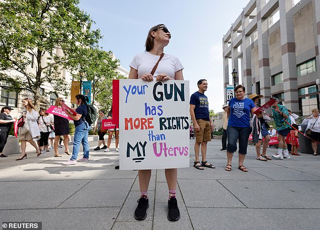 70962223-12081351-An_abortion_rights_activist_is_seen_on_Saturday_in_Raleigh_North-a-106_1684039256547